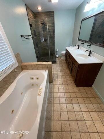 full bathroom featuring tile patterned floors, vanity, toilet, and independent shower and bath