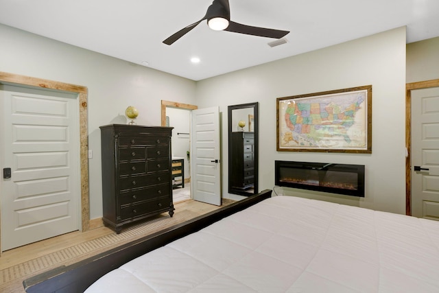 120 Hummingbird Way, Copperhill, TN 37317 - bedroom featuring wood finished floors, ceiling fan, a glass covered fireplace, and recessed lighting