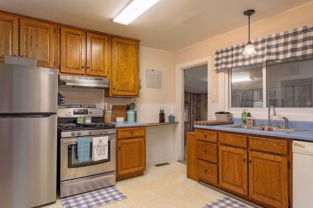 229 Plerce Hill St, Spring City, TN 37381 - kitchen with stainless steel appliances, under cabinet range hood, brown cabinets, and a sink