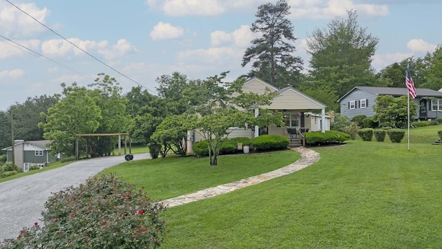 229 Plerce Hill St, Spring City, TN 37381 - view of property hidden behind natural elements with a front yard, covered porch, gravel driveway, and a carport