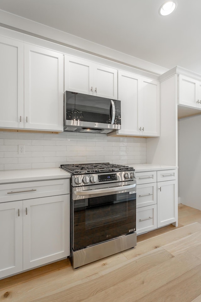 5118 Judd Way NW Unit 21, Cleveland, TN 37312 - kitchen featuring stainless steel appliances, light countertops, decorative backsplash, and white cabinets