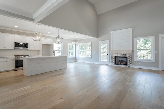 5118 Judd Way NW Unit 21, Cleveland, TN 37312 - kitchen featuring stainless steel appliances, a sink, open floor plan, a chandelier, and tasteful backsplash