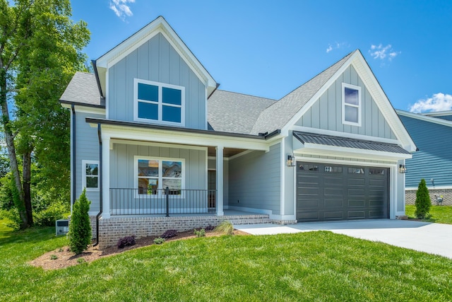 5118 Judd Way NW Unit 21, Cleveland, TN 37312 - view of front of home with board and batten siding, covered porch, a shingled roof, concrete driveway, and a front yard