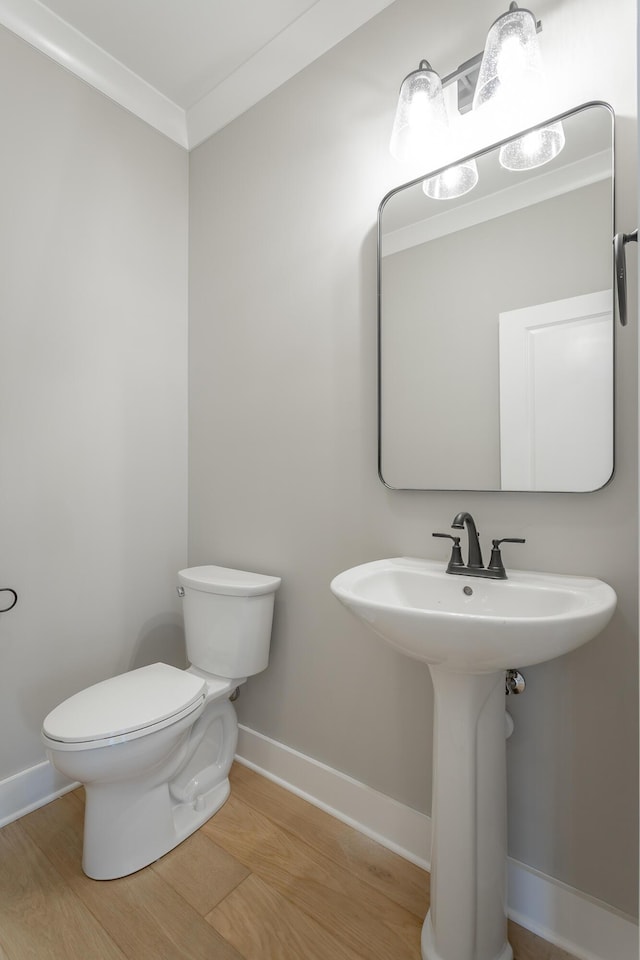 5118 Judd Way NW Unit 21, Cleveland, TN 37312 - bathroom with wood finished floors, toilet, baseboards, a sink, and ornamental molding