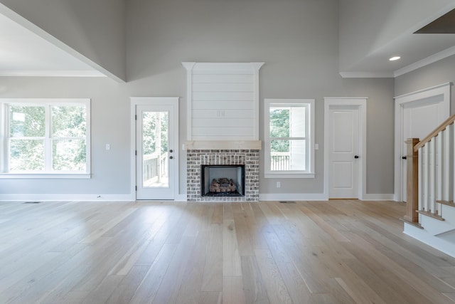 5118 Judd Way NW Unit 21, Cleveland, TN 37312 - unfurnished living room featuring stairs, light wood-type flooring, baseboards, plenty of natural light, and ornamental molding