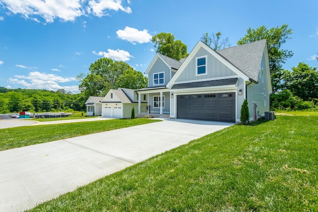 5118 Judd Way NW Unit 21, Cleveland, TN 37312 - view of front of property featuring board and batten siding, driveway, central AC, a front lawn, and a shingled roof