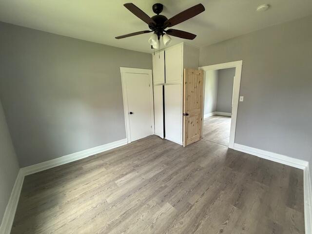 1220 Hardwick St SE, Cleveland, TN 37311 - unfurnished bedroom with baseboards, wood finished floors, a closet, and ceiling fan