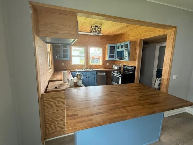 1220 Hardwick St SE, Cleveland, TN 37311 - kitchen featuring appliances with stainless steel finishes, wood counters, a sink, a peninsula, and glass insert cabinets