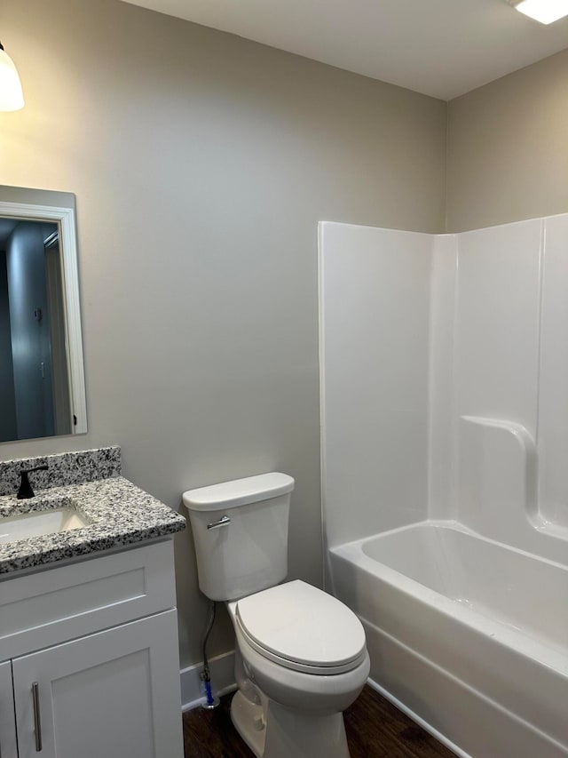 full bathroom featuring hardwood / wood-style floors, vanity, bathtub / shower combination, and toilet