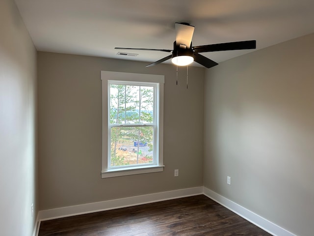 spare room with dark hardwood / wood-style floors and ceiling fan