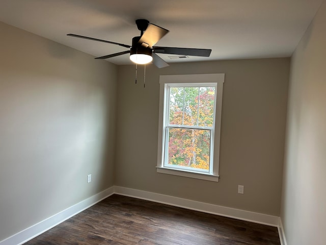 empty room with dark hardwood / wood-style floors and ceiling fan