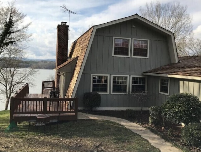 14318 Bluffview Dr, Birchwood, TN 37308 - back of house with a chimney, a gambrel roof, a deck with water view, and board and batten siding