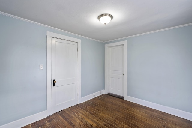 spare room with dark hardwood / wood-style floors, ornamental molding, and a textured ceiling