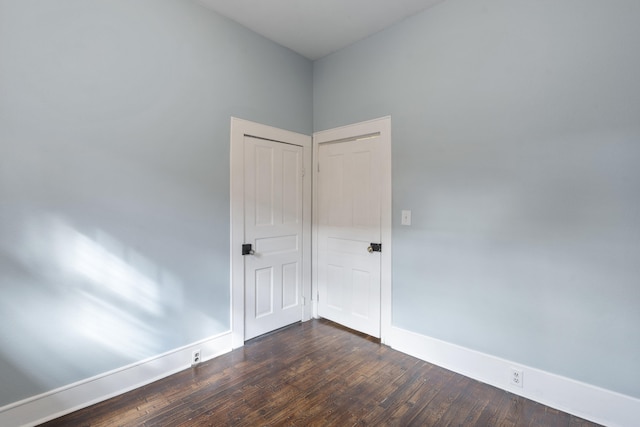 unfurnished room with dark hardwood / wood-style floors