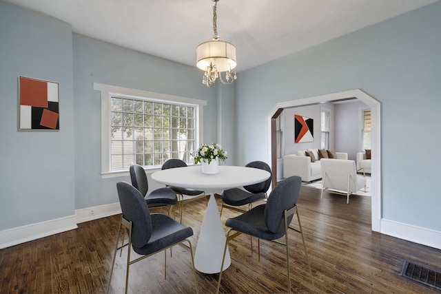 dining room with a chandelier and dark wood-type flooring