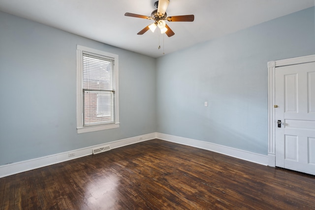 spare room featuring ceiling fan and dark hardwood / wood-style flooring