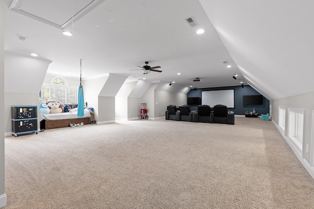 carpeted home theater room with ceiling fan and lofted ceiling