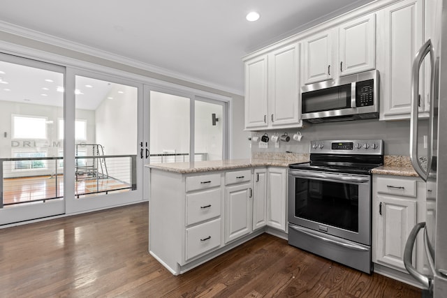 kitchen with crown molding, white cabinetry, stainless steel appliances, and dark wood-type flooring