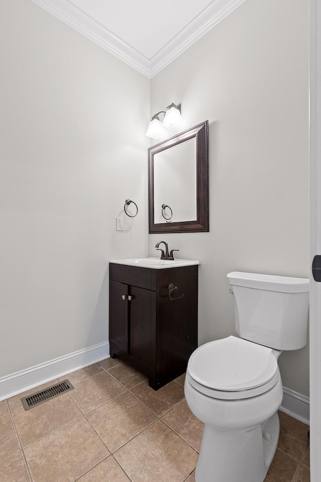 bathroom featuring tile patterned floors, vanity, toilet, and ornamental molding