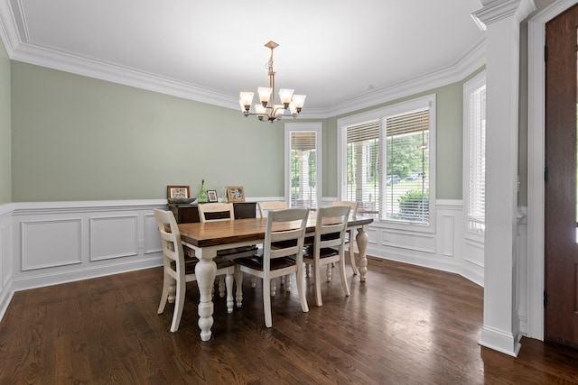 dining area featuring crown molding, dark wood-type flooring, and an inviting chandelier