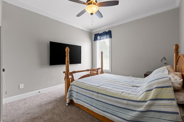 carpeted bedroom with ceiling fan and crown molding