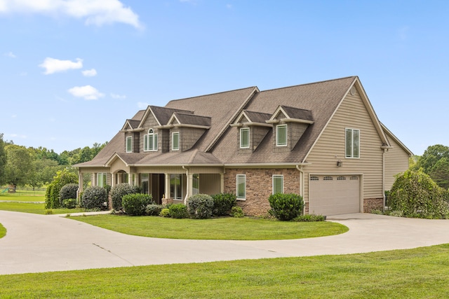 view of front of property with a garage and a front lawn