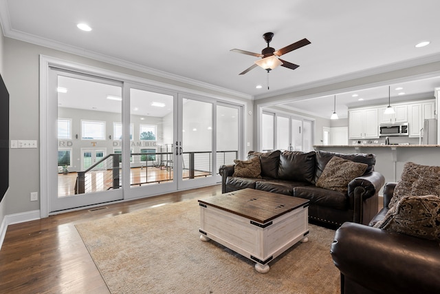 living room featuring crown molding, ceiling fan, and hardwood / wood-style flooring