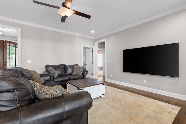 living room featuring ceiling fan, crown molding, and dark wood-type flooring