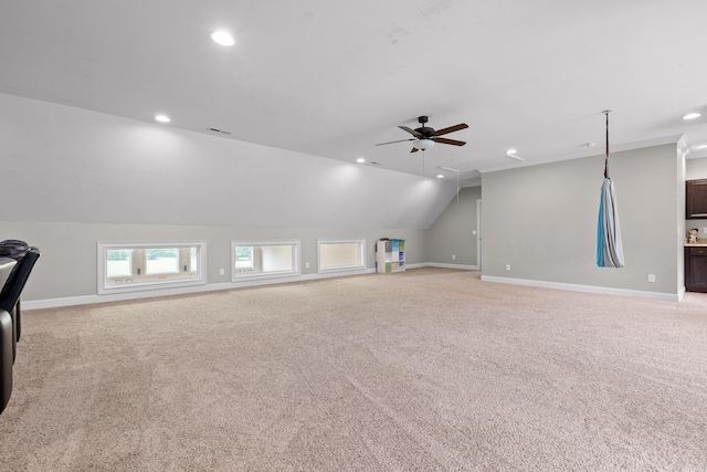 additional living space with light colored carpet, ceiling fan, and lofted ceiling