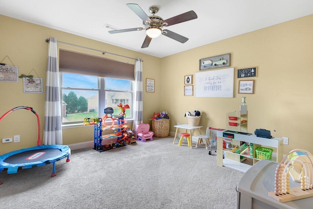 recreation room featuring carpet and ceiling fan