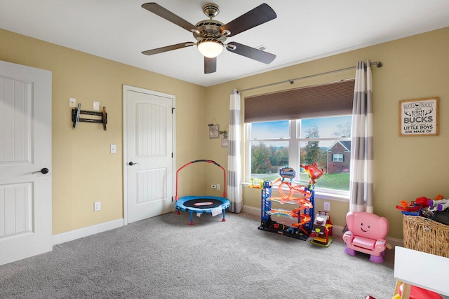 recreation room with carpet flooring and ceiling fan