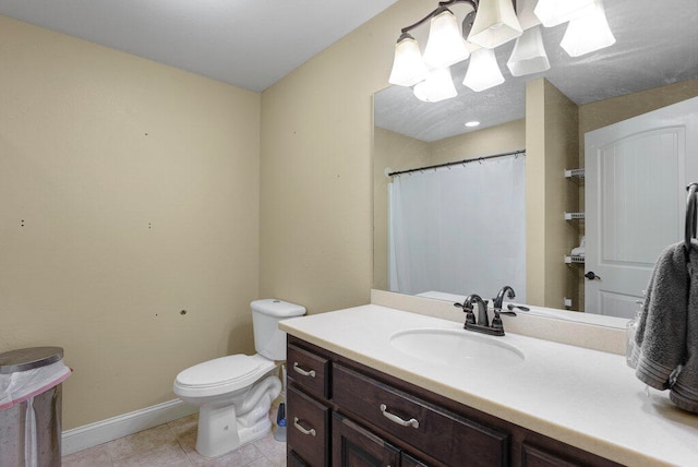 bathroom featuring tile patterned flooring, vanity, and toilet