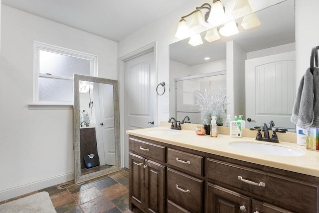 bathroom featuring vanity and a shower with door