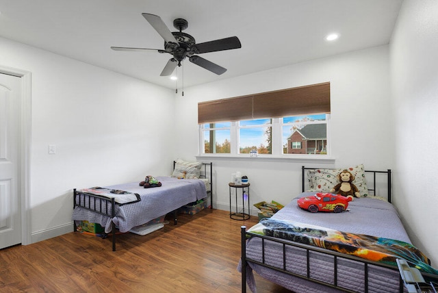 bedroom with ceiling fan and hardwood / wood-style flooring