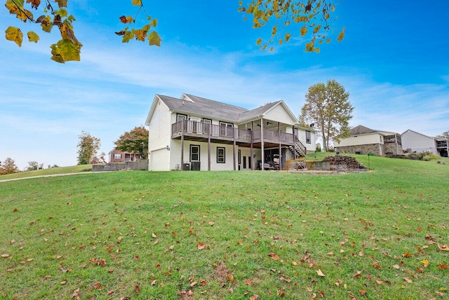 back of house with a yard, a deck, and a garage