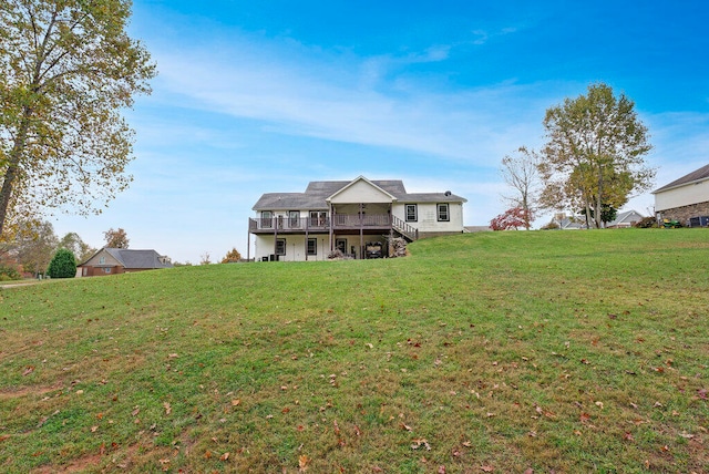 rear view of property with a lawn and a wooden deck