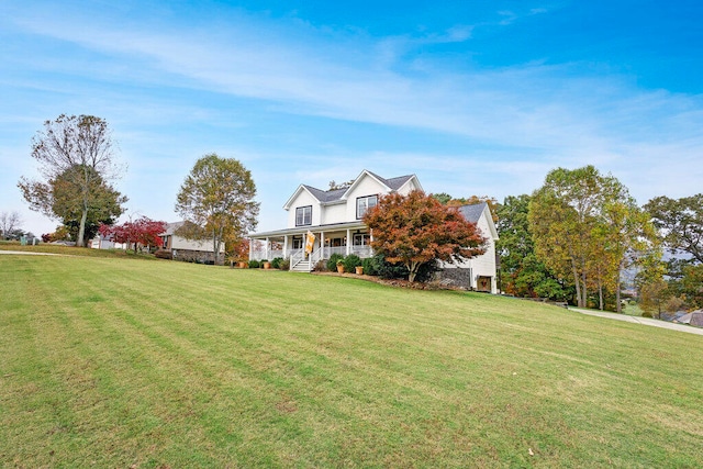 cape cod-style house with covered porch and a front yard