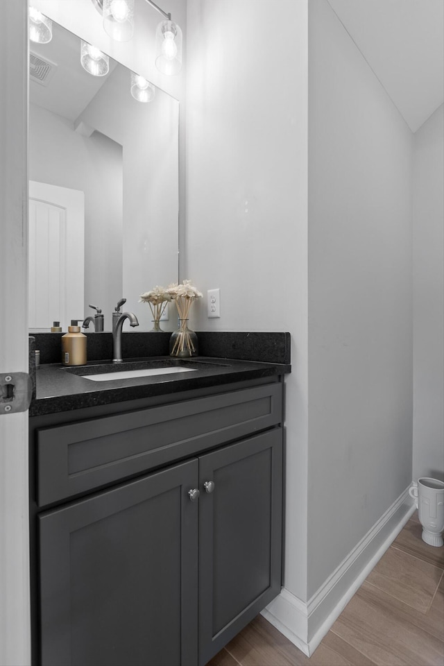 5086 Oop Rd, Chattanooga, TN 37416 - bathroom with vanity, wood finished floors, toilet, and baseboards