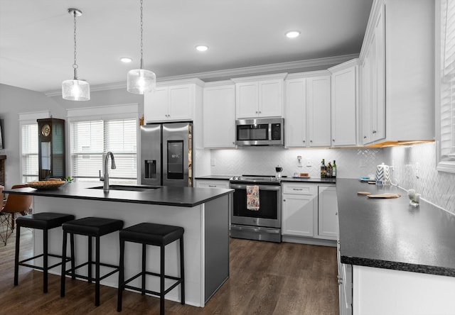 5086 Oop Rd, Chattanooga, TN 37416 - kitchen with appliances with stainless steel finishes, a sink, dark countertops, ornamental molding, and recessed lighting