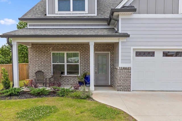 5086 Oop Rd, Chattanooga, TN 37416 - view of exterior entry featuring brick siding, a shingled roof, and driveway