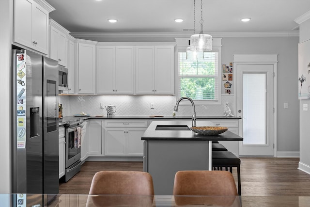 5086 Oop Rd, Chattanooga, TN 37416 - kitchen featuring appliances with stainless steel finishes, a sink, dark countertops, tasteful backsplash, and white cabinetry