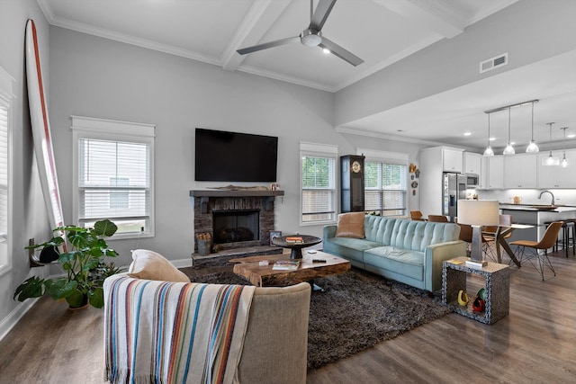 5086 Oop Rd, Chattanooga, TN 37416 - living room with dark wood-style floors, a ceiling fan, a stone fireplace, beam ceiling, and baseboards