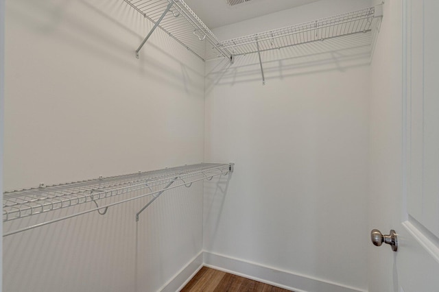 spacious closet featuring dark wood-type flooring