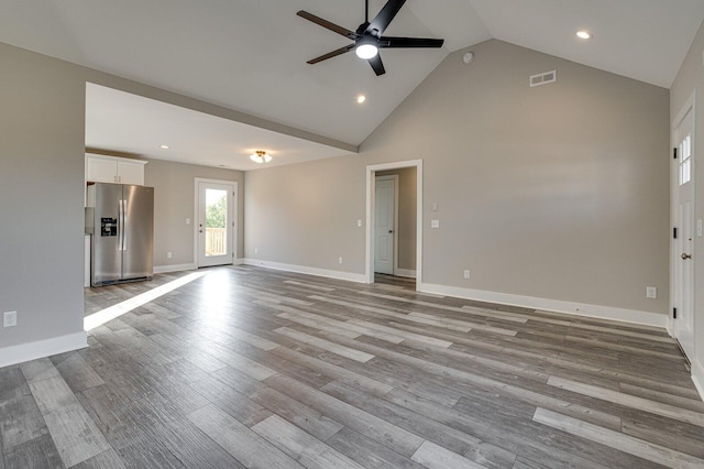 unfurnished living room featuring high vaulted ceiling, light hardwood / wood-style flooring, and ceiling fan