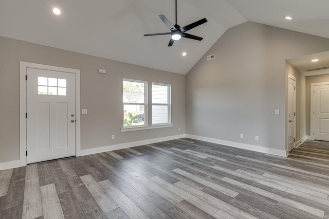 foyer with ceiling fan, high vaulted ceiling, a healthy amount of sunlight, and light wood-type flooring