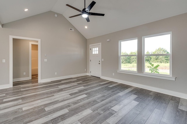 unfurnished living room with ceiling fan, high vaulted ceiling, and light wood-type flooring