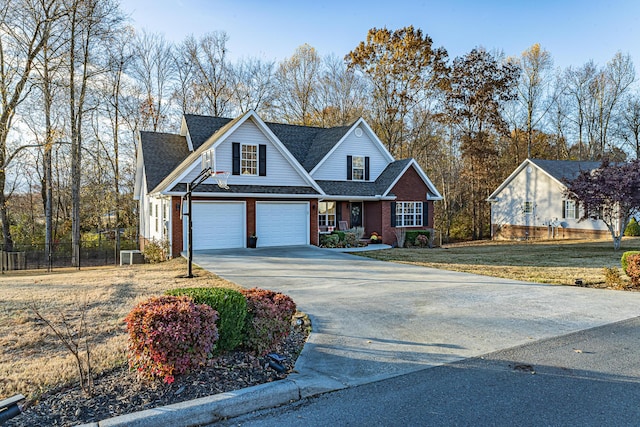 traditional-style home featuring brick siding, driveway, a front lawn, and fence