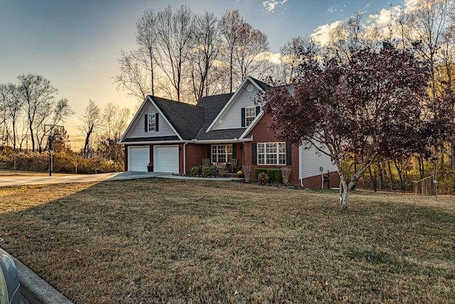 traditional home with driveway, an attached garage, and a yard