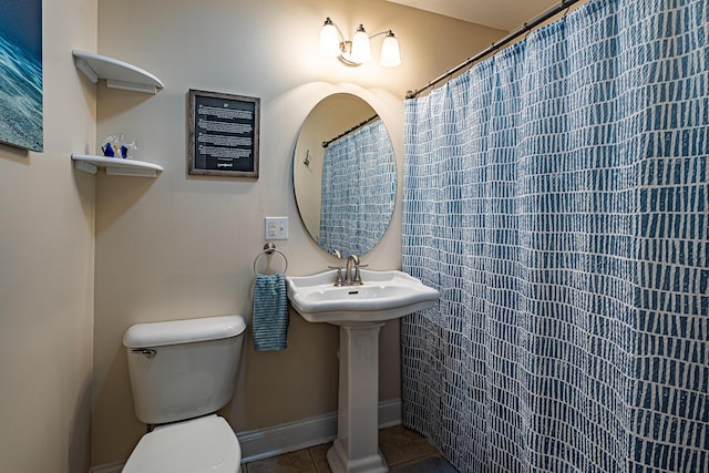 full bath with tile patterned floors, toilet, baseboards, and a sink