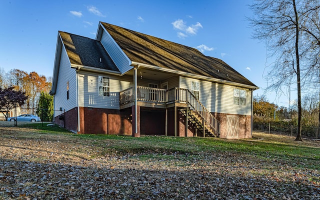 back of property with stairs, fence, a lawn, and a wooden deck